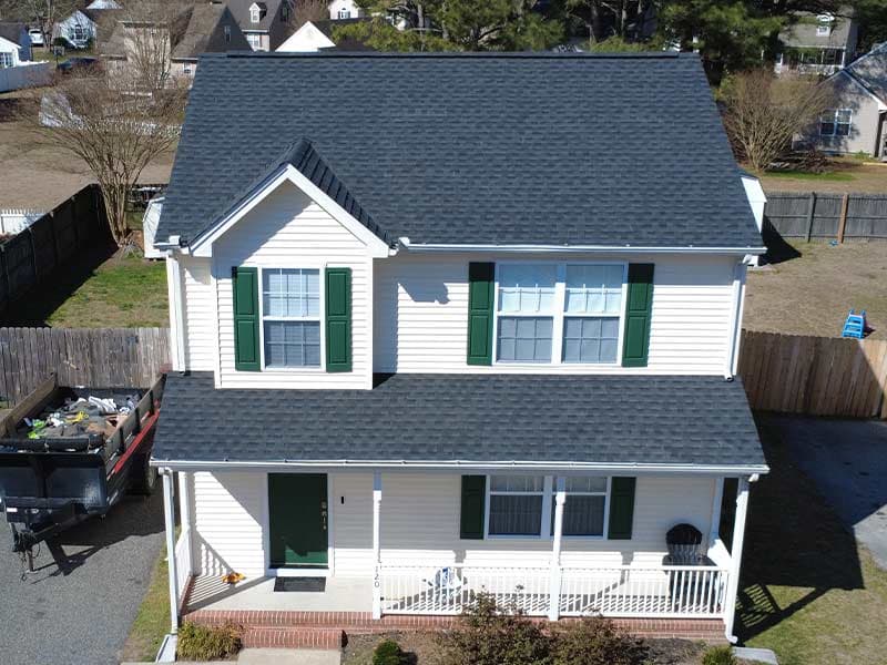 Two-story white colonial home with a new dark architectural shingle roof